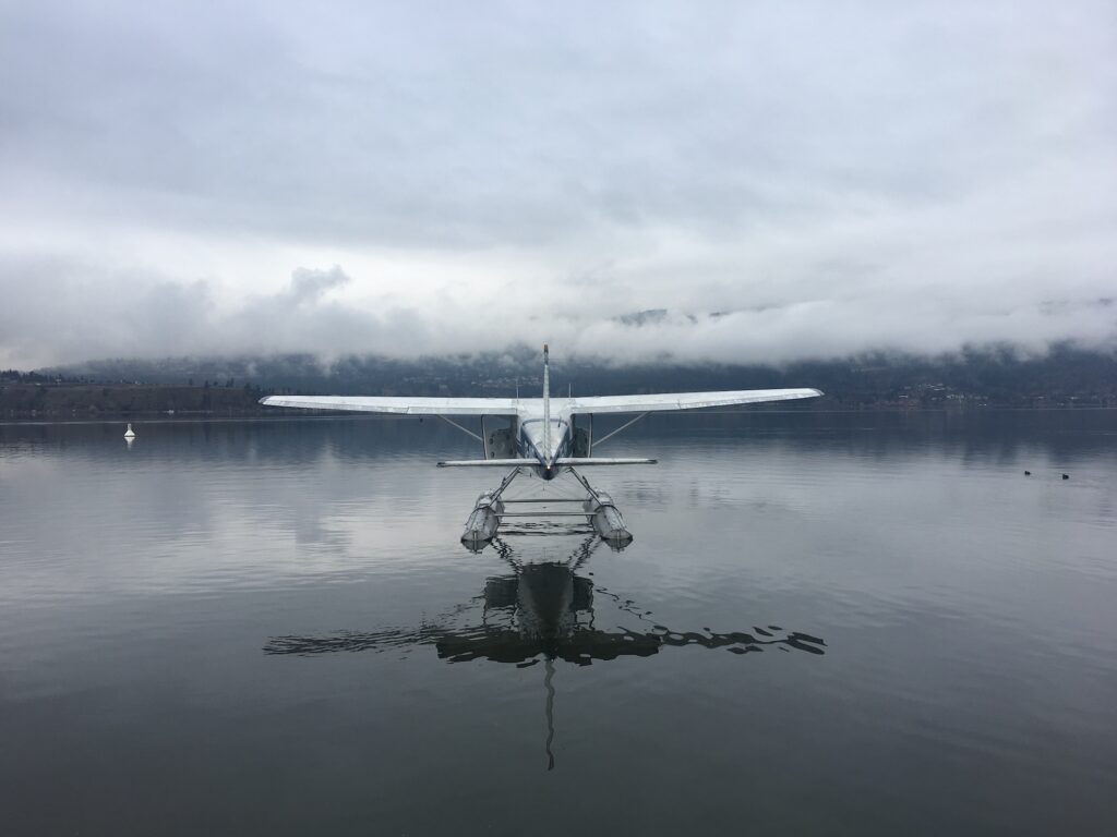 float plane resting on a misty lake